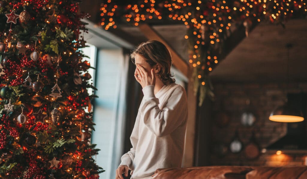 Portrait Of Candid Authentic Dreamer Boy Teenager In Sadness Depressing Emotion At Home Xmas